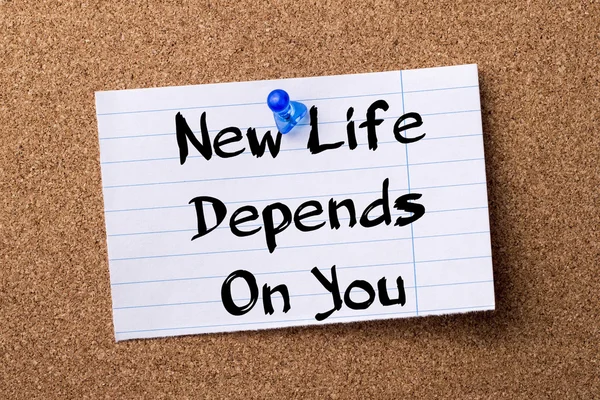 New Life Depends On You - teared note paper pinned on bulletin b