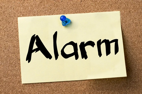 Alarm - adhesive label pinned on bulletin board