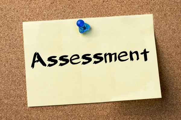 Assessment - adhesive label pinned on bulletin board