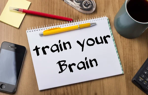 Train your Brain - Note Pad With Text On Wooden Table