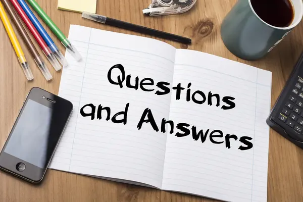 Questions and Answers - Note Pad With Text On Wooden Table