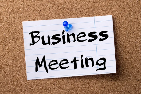 Business Meeting - teared note paper  pinned on bulletin board