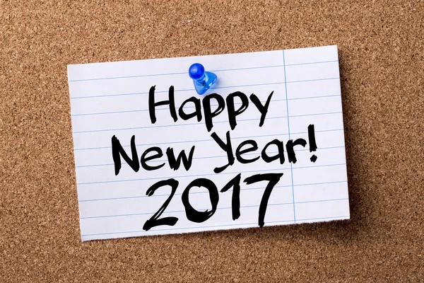 Happy New Year 2017 - teared note paper  pinned on bulletin boar