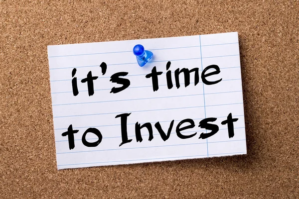 It\'s time to Invest - teared note paper  pinned on bulletin bo