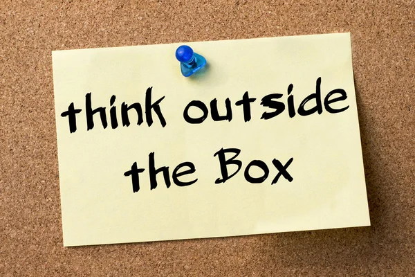 Think Outside the Box - adhesive label pinned on bulletin board