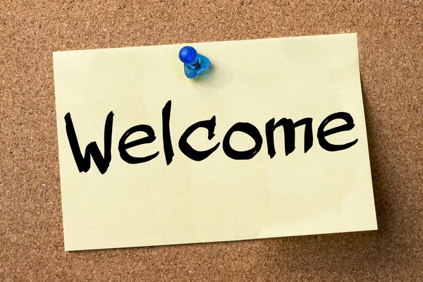 Welcome - adhesive label pinned on bulletin board