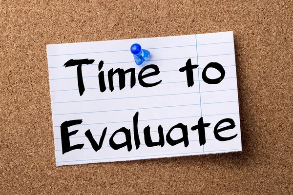 Time to Evaluate - teared note paper pinned on bulletin board
