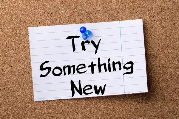 Try Something New - teared note paper pinned on bulletin board