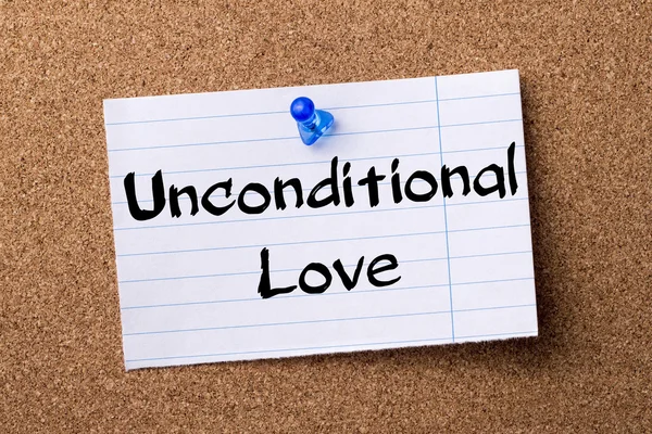 Unconditional Love - teared note paper pinned on bulletin board