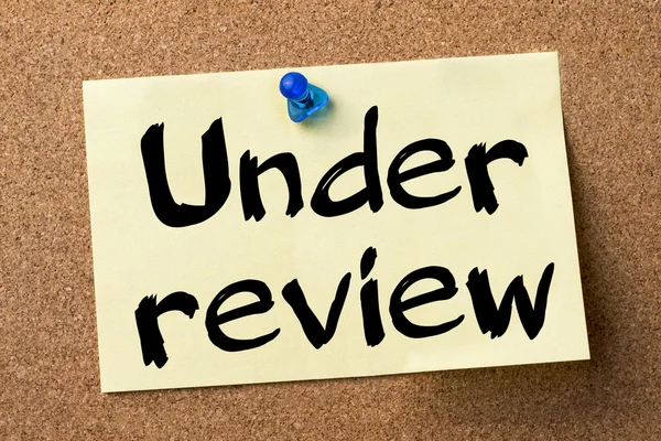 Under review - adhesive label pinned on bulletin board