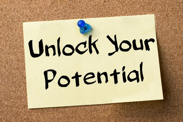 Unlock Your Potential - adhesive label pinned on bulletin board