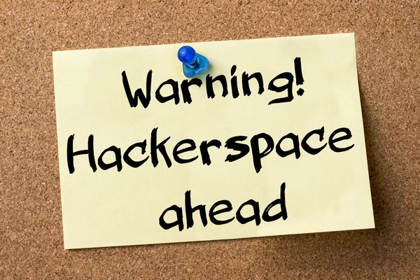 Warning! Hackerspace Ahead - adhesive label pinned on bulletin b