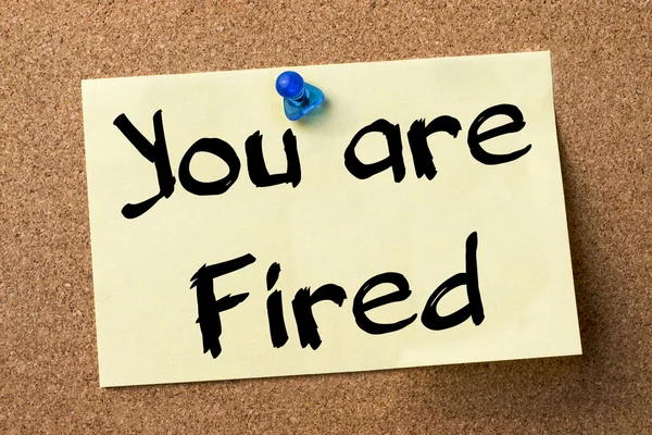You are Fired - adhesive label pinned on bulletin board