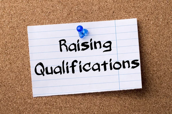 Raising Qualifications - teared note paper pinned on bulletin bo