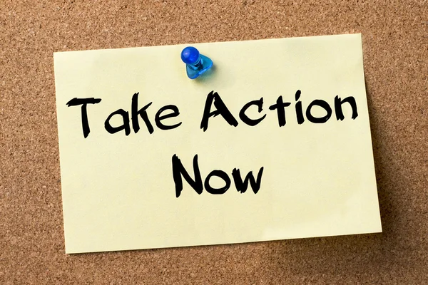 Take Action Now - adhesive label pinned on bulletin board