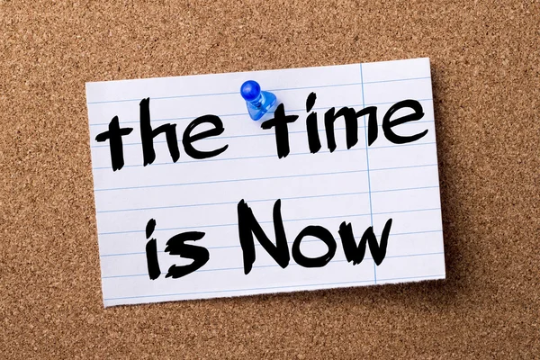 The Time is Now - teared note paper pinned on bulletin board