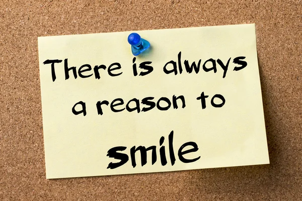 There is always a reason to smile - adhesive label pinned on bul