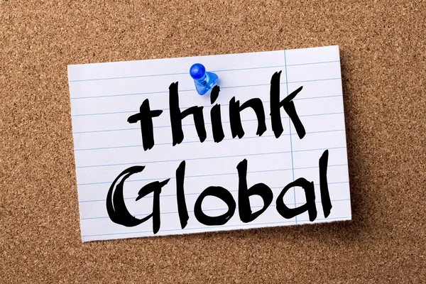 Think Global - teared note paper pinned on bulletin board