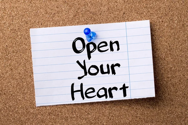 Open Your Heart - teared note paper pinned on bulletin board