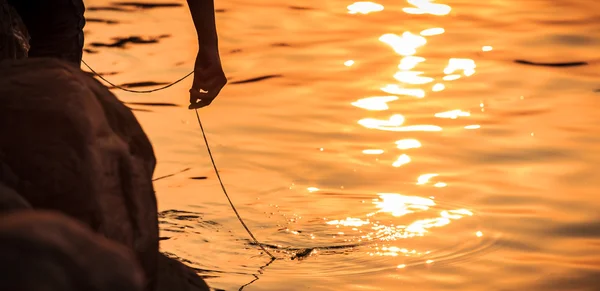 Hand in the sunset silhouette