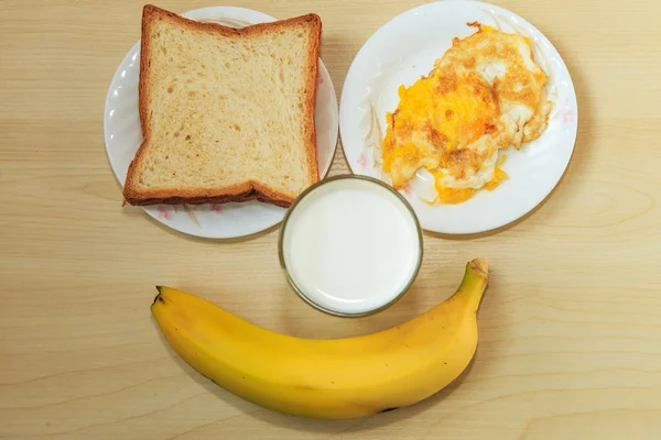 Bread and milk for breakfast eggs fruits