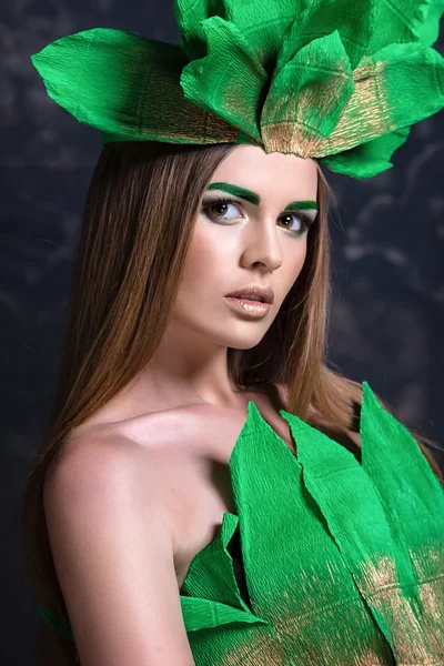 Fashion portrait beautiful  girl model  posing, decorative green dress crown