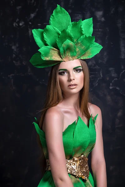 Fashion portrait beautiful  girl model  posing, decorative green dress crown