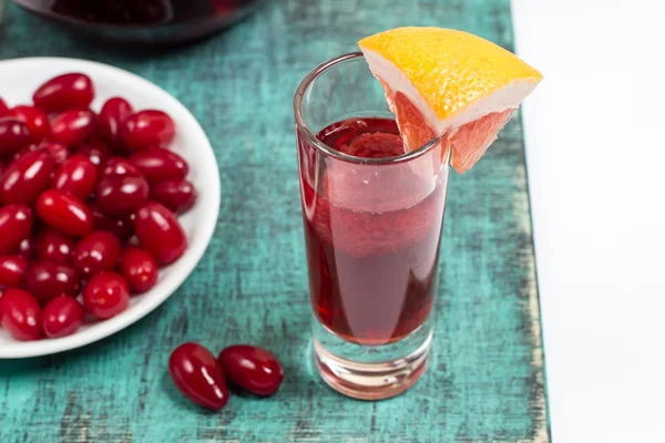 Summer sangria cocktail in small glass , plate with dogwood berries