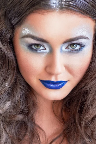 Beauty girl, blue lips, silver eyeshadow. Snowy hair. Young model