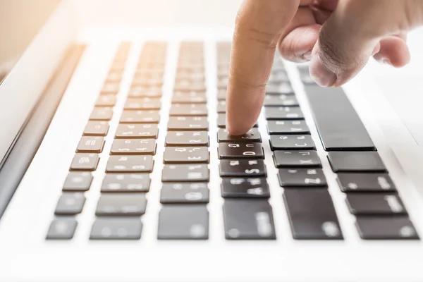 Pointer finger press a button on laptop keyboard
