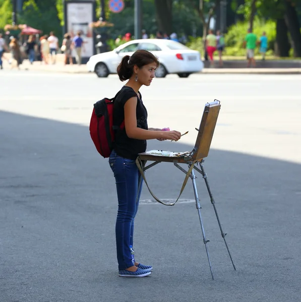 Street artist with an easel