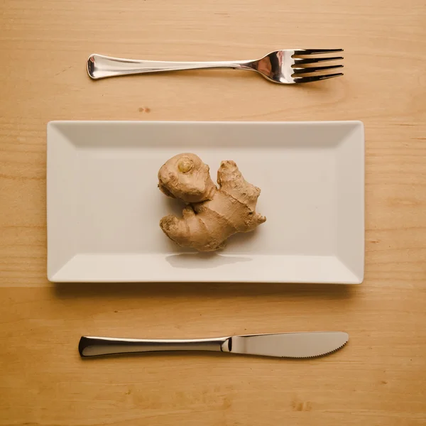 Vegan low-carb diet raw ginger root on rectangular plate