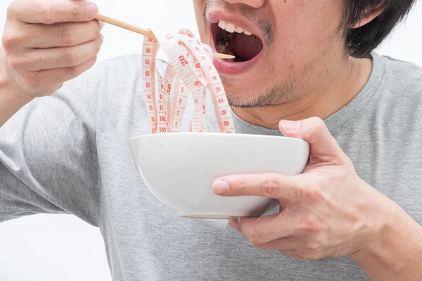 Asian man eating waist measure