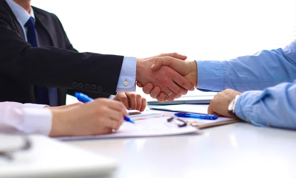 Business handshake. Two businessman shaking hands with each other in the office