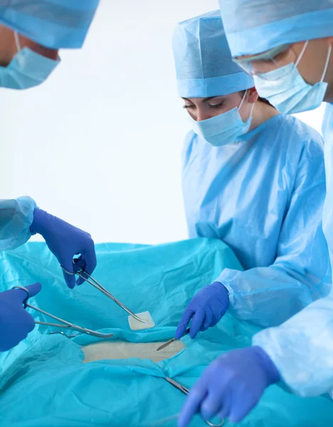 Team of surgeon in uniform perform operation on a patient at cardiac surgery clinic