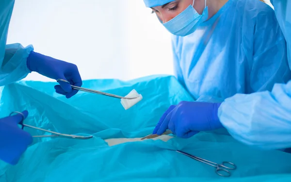 Team of surgeon in uniform perform operation on a patient at cardiac surgery clinic