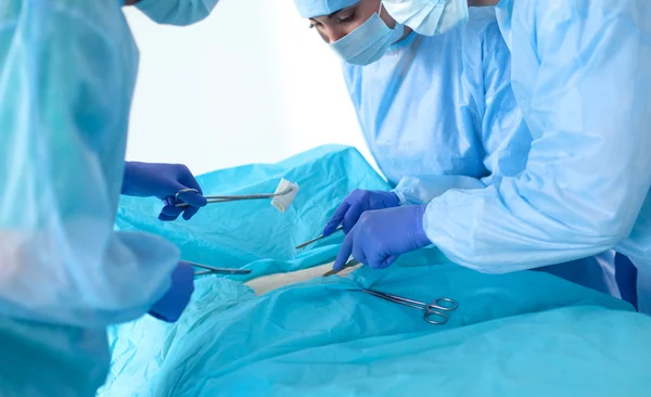 Team of surgeon in uniform perform operation on a patient at cardiac surgery clinic