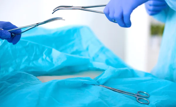 Team of surgeon in uniform perform operation on a patient at cardiac surgery clinic