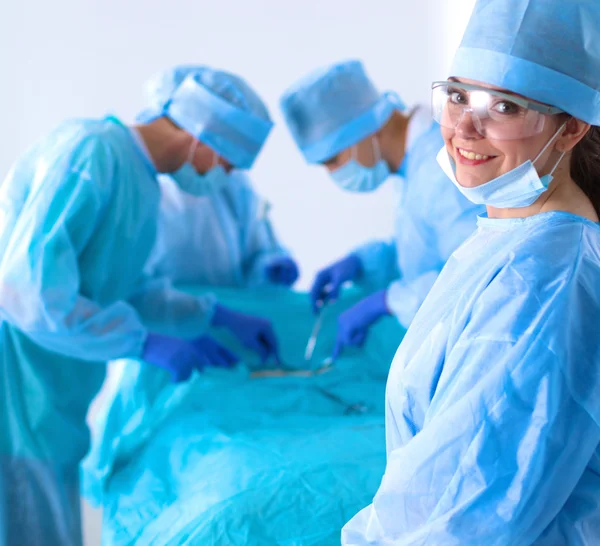 Team of surgeon in uniform perform operation on a patient at cardiac surgery clinic