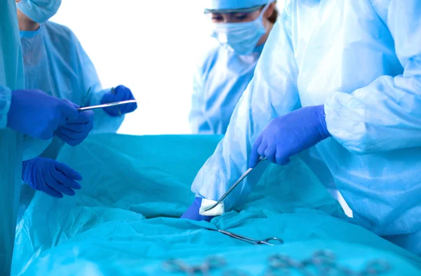 Team of surgeon in uniform perform operation on a patient at cardiac surgery clinic