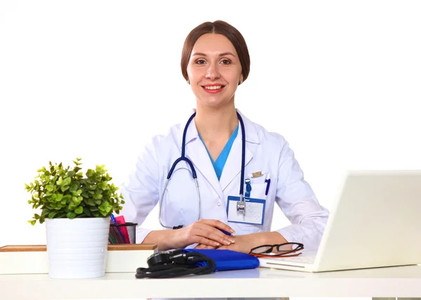 Happy smiling young beautiful female doctor showing blank area for sign or copyspace, isolated over white background