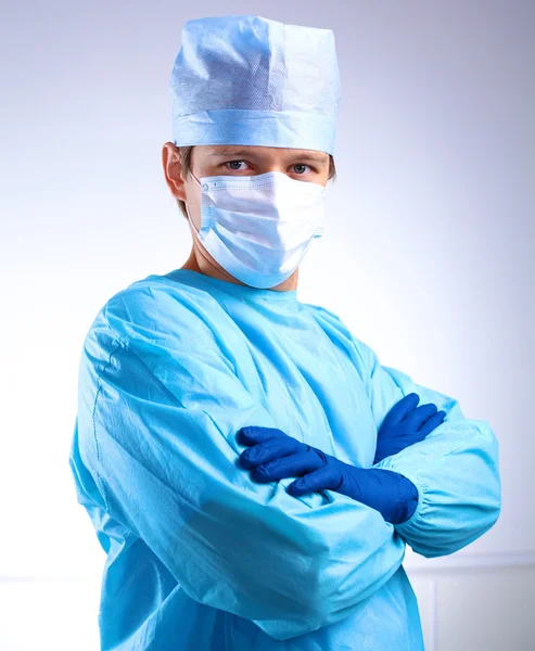 Young surgeon standing with his arms crossed