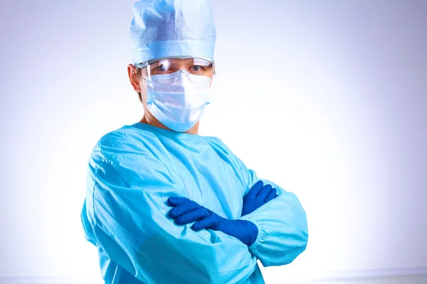 Young surgeon standing with his arms crossed