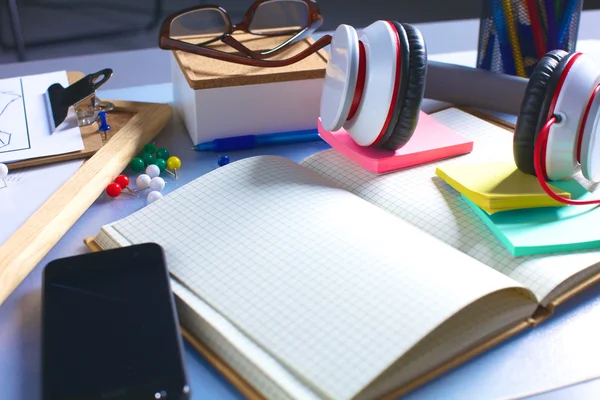 Office desk with papers and headphones