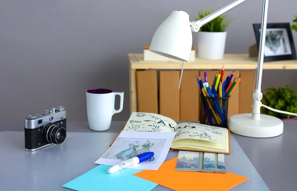 Desk of an artist with lots  stationery objects. Studio shot on wooden background