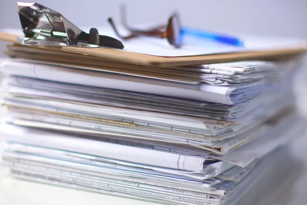 Office desk a stack of computer paper reports work forms