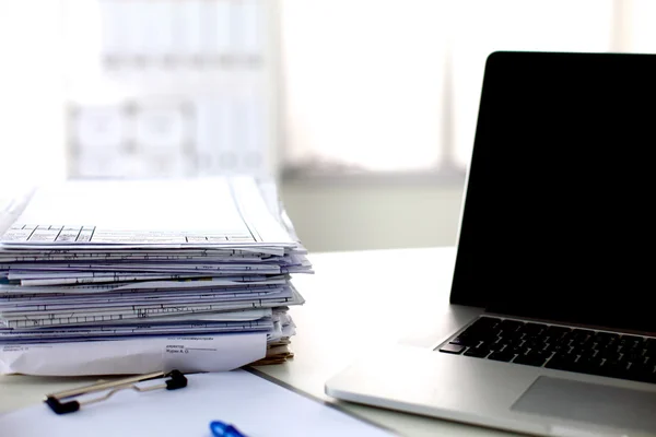 Office desk a stack of computer paper reports work forms