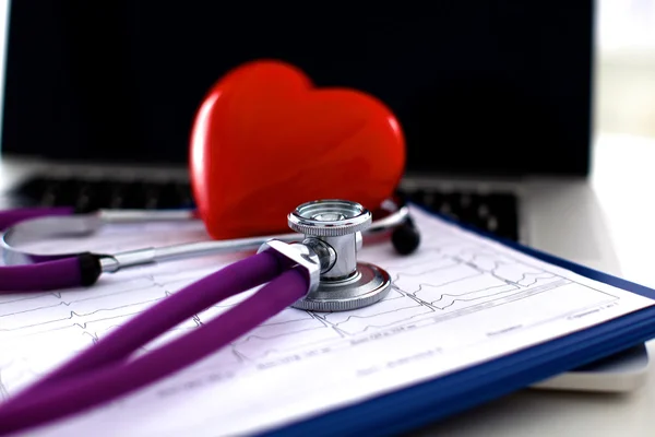 Medical stethoscope and heart isolated on white