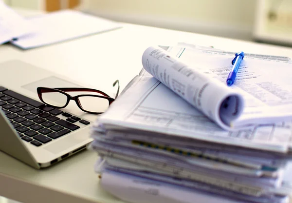 Office desk a stack of computer paper reports work forms