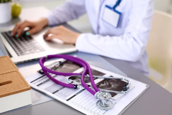 Hands of female medical worker using smartphone